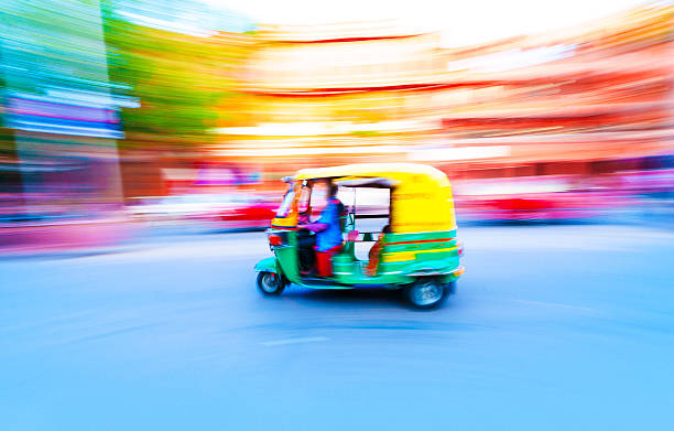 Tuk Tuk Taxi India Traditional tuk-tuk from Jaipur, India - speeding in the afternoon panning/motion blur auto rickshaw taxi india stock pictures, royalty-free photos & images