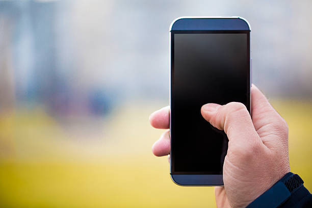 istock Man Holding Smartphone Against Green Background 476305012