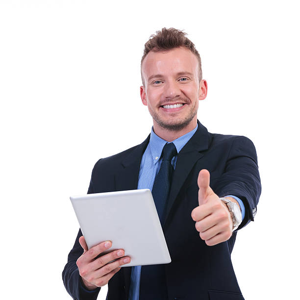 istock business man holds tablet and shows thumb up 476312517