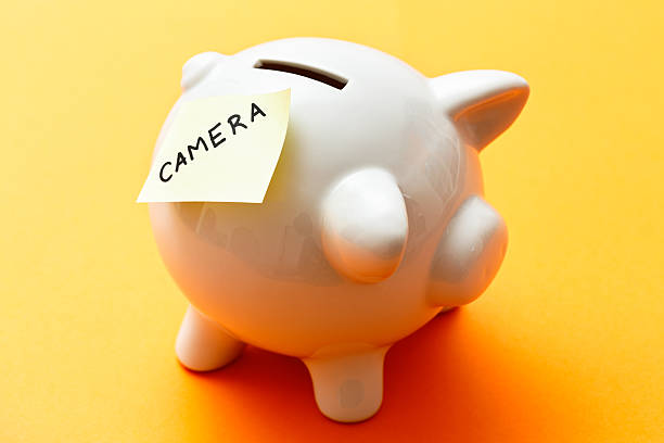 istock Targeted saving: piggybank with label saying CAMERA 476319963