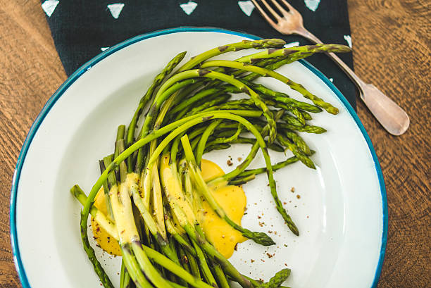 Asparagus Boiled green asparagus dressed in mustard vinegar and olive oil dressing mayonnaise or hollandaise sauce hollandaise sauce stock pictures, royalty-free photos & images