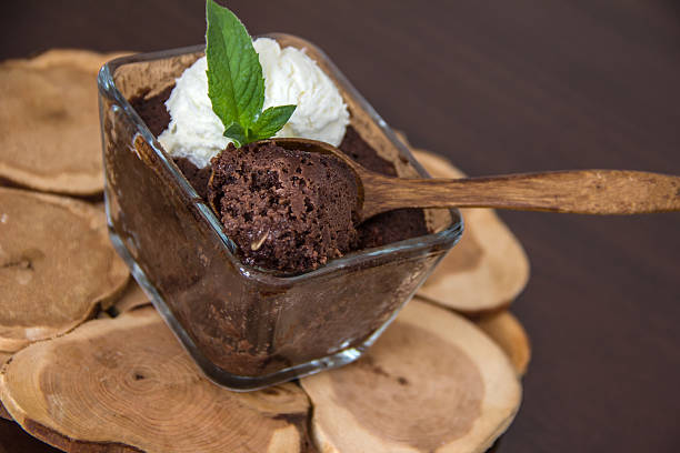istock appetizing chocolate brownie with vanilla ice cream against wood  background 476323480