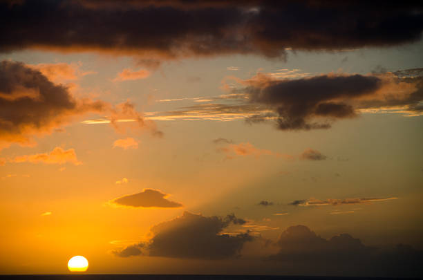 istock The sun showing through the clouds with dark yellow/orange sky 476323704