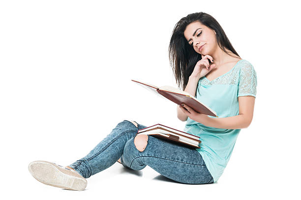 istock Young Student Girl Holding Books and Thinking 476324794