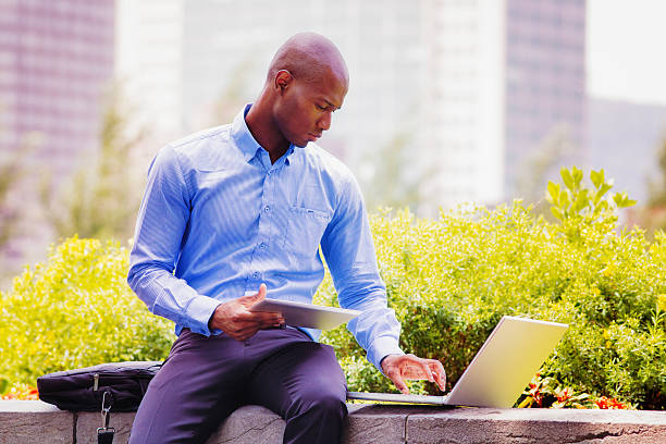 istock Office worker job hunter salesman working outdoors with laptop tablet 476327106