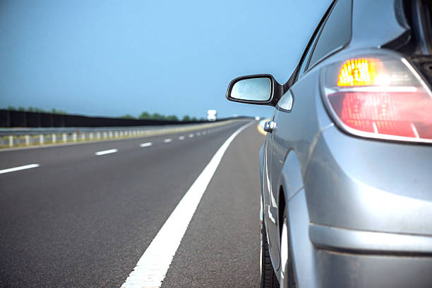 istock new car driving fast on a road in mountains 476327980