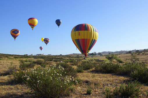 Temecula, California,USA- May 31,2015. Colorful hot air balloons soaring over Temecula wine country at the 2015 Temecula Balloon and Wine Festival. The Temecula Balloon and Wine Festival takes place in the spring at Lake Skinner in the Temecula wine country about 2 hours from Los Angeles.