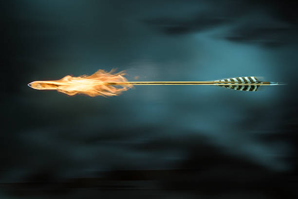 Arrow on fire Arrow of natural materials in flight with fire. bow and arrow photos stock pictures, royalty-free photos & images