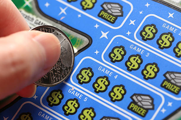 Close up woman scratching lottery tickets stock photo