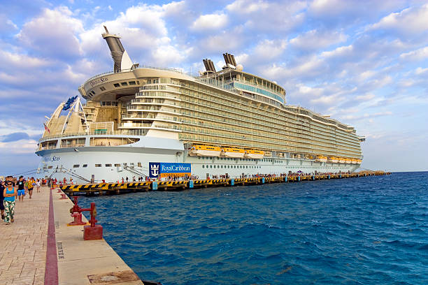 Royal Caribbean, Oasis of the Seas Cruise Ship. Cozumel, Mexico – December 24, 2014: Vacation Travelers Exiting Royal Caribbean Cruise Ship, Oasis of the Seas at Docking Station. san miguel de cozumel stock pictures, royalty-free photos & images