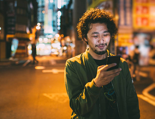 istock Young japanese man texting on the phone 476342140