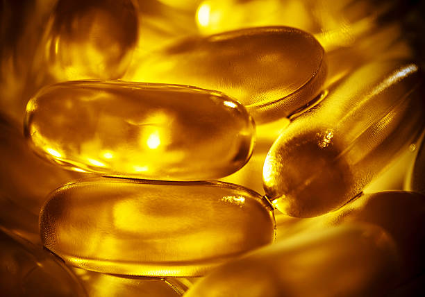 istock Gel capsules isolated on white. Vitamin D 476345452