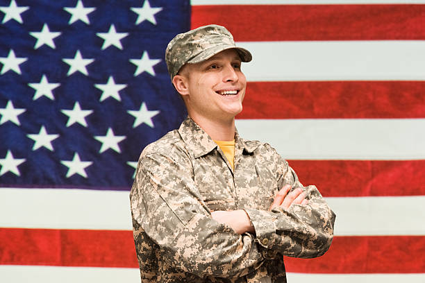 istock Army man standing in front of American flag 476348130
