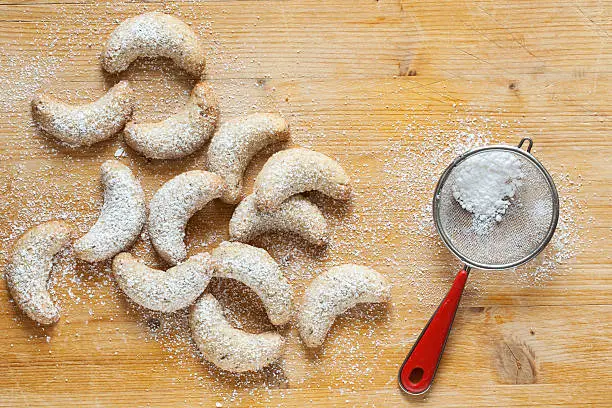 Fresh Vanilla Cookies With Powdered Sugar For Christmas on wooden background