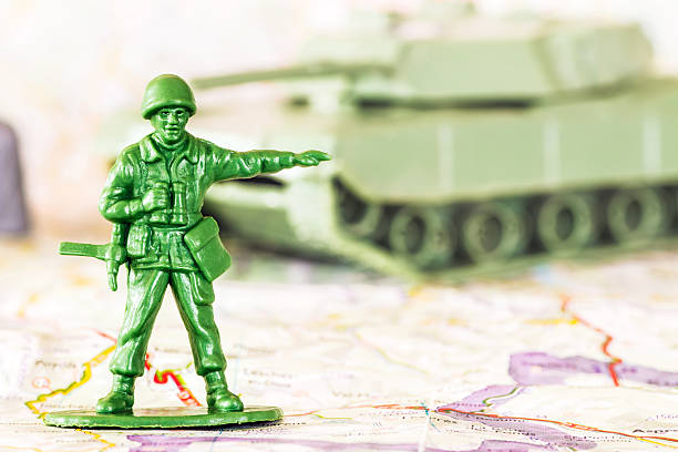 istock Leadership concept with little green armed soldier toy 476348834