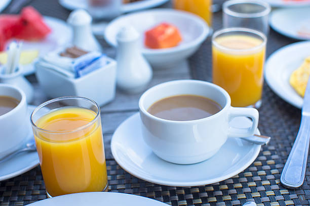 istock Delicious tasty cappuccino and fresh juice for breakfast 476349032