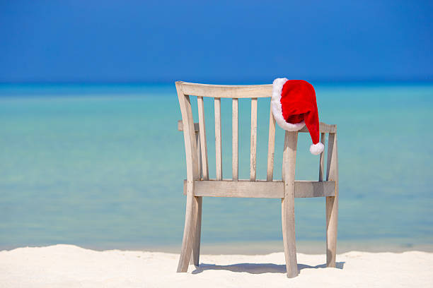 istock Red santa hat on beach chair at tropical vacation 476349160