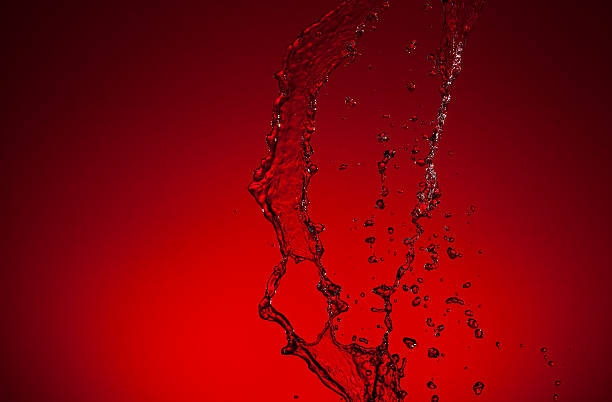 istock Stream of water on a red background 476351504