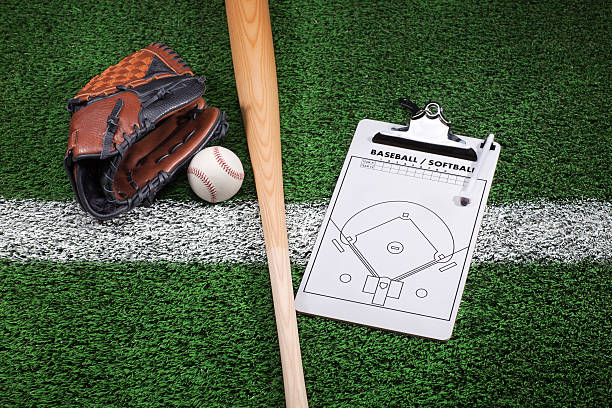 istock Baseball mitt, bat and clipboard on grass with stripe 476351599