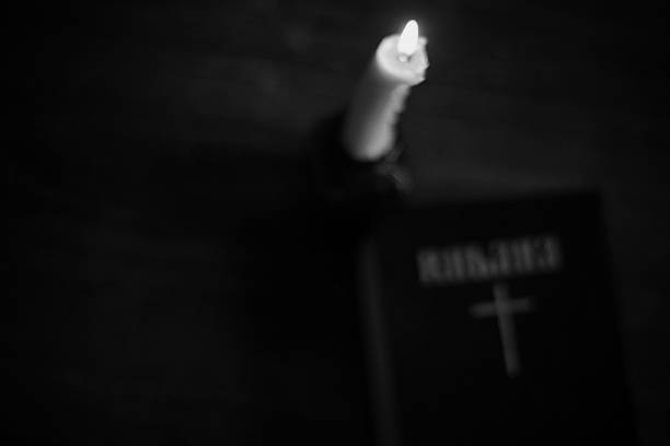 istock burning candle and bible religion 476351816