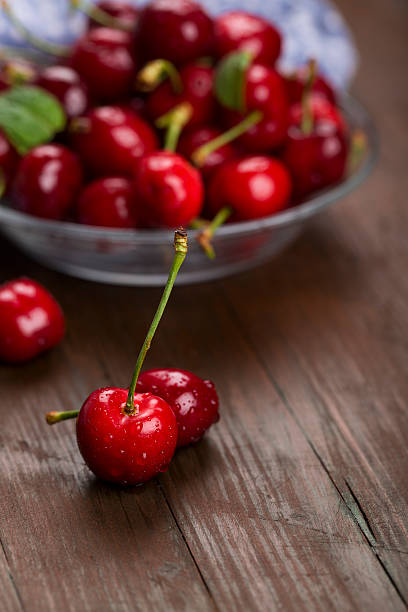 cherries on a dark wood background stock photo