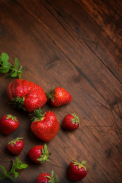strawberry on a dark wood background stock photo