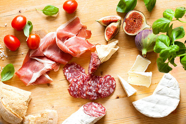 Chopping board of Assorted Cured Meats and Cheese stock photo