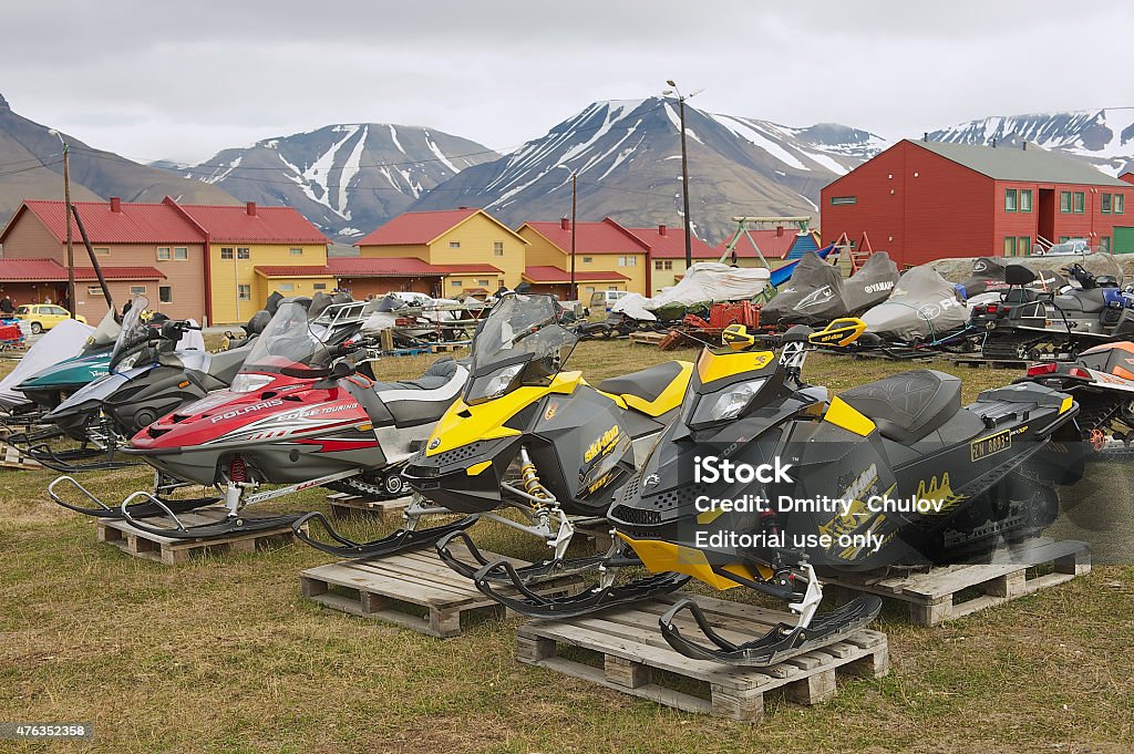 Snowmobiles parked for a short arctic summer in Longyearbyen, Norway. Longyearbyen, Norway - September 01, 2011: View to the snowmobiles parked outside for a short arctic summer in Longyearbyen, Norway. 2015 Stock Photo