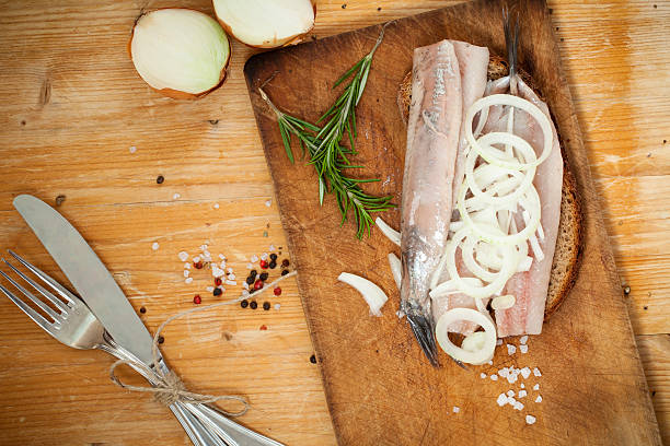 Portion of typical Dutch herring on bread stock photo