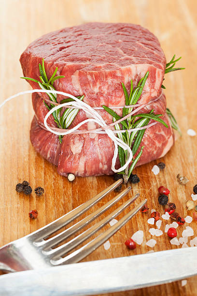 fresh raw beef fillet mignon on old  wooden background stock photo
