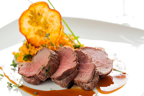 Roasted deer with smashed sweet potatoes and chips stock photo