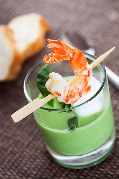 Pea capuccino soup  with shrimp stock photo