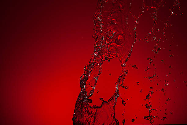 istock Texture of water on a red background 476354838