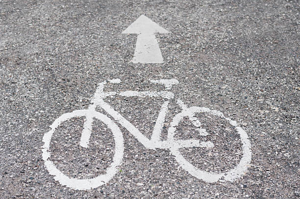 istock Road with white arrow and bicycle symbol 476355096