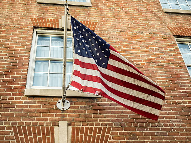 istock American Flag Flying on Brick Building 476358686