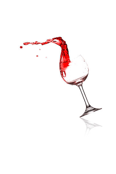 red wine pouring into wine glass stock photo