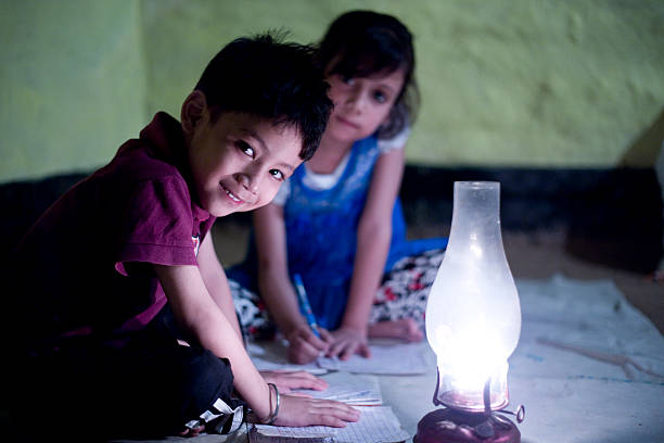 istock Rural girl and boy studying in lantern 476359452