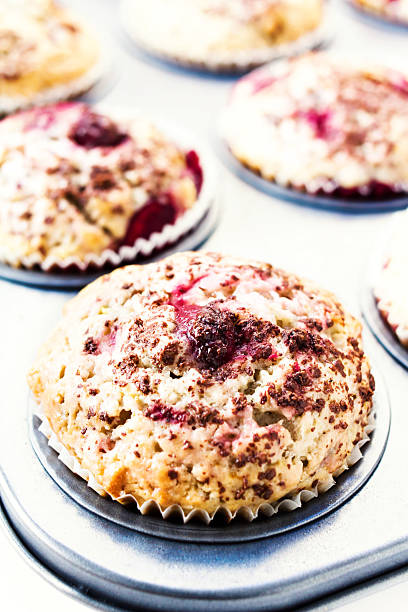 istock Berry muffins with chocolate sprinkles in baking tray. Closeup. 476360445