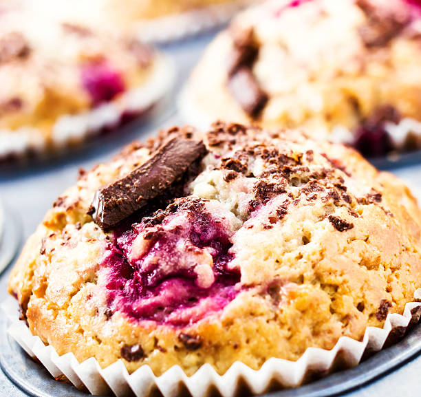 istock Cherry muffins with chocolate sprinkles in baking tin. Macro. To 476360627