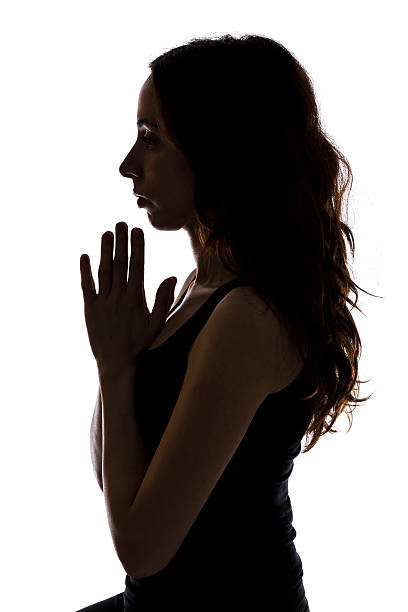 istock Meditating young woman, silhouette 476361737