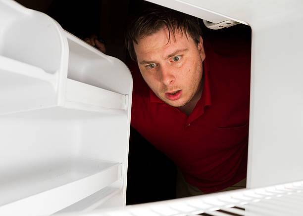 istock Man looks to his fridge for a snack 476362055
