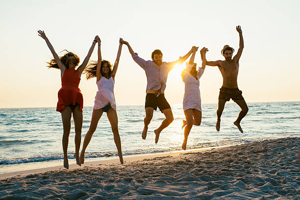 istock Five happy friends jumping on the beach for summer 476366476