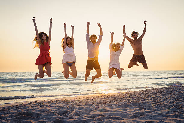 istock Five happy friends jumping on the beach for summer 476366480