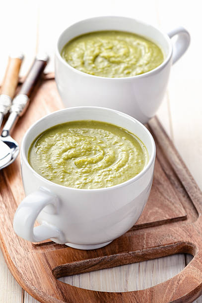 Glum green pea soup in mugs stock photo