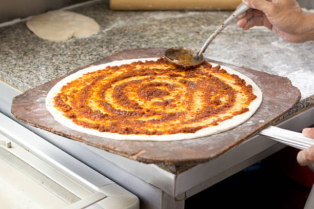 istock Closeup hand of chef baker making pizza at kitchen 476369319