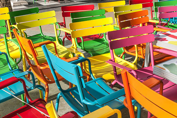 Multicolor chairs Cheerful and colorful collection of chairs in the street. beautiful multi colored tranquil scene enjoyment stock pictures, royalty-free photos & images