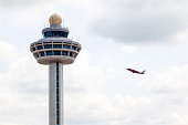 Singapore Changi Airport Traffic Controller Tower With Plane Takeoff