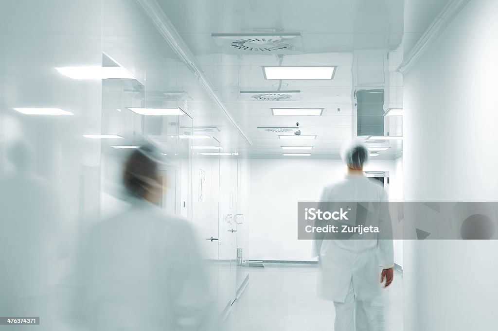 Working people with white uniforms walking in modern  factory environment Blurred Motion Stock Photo