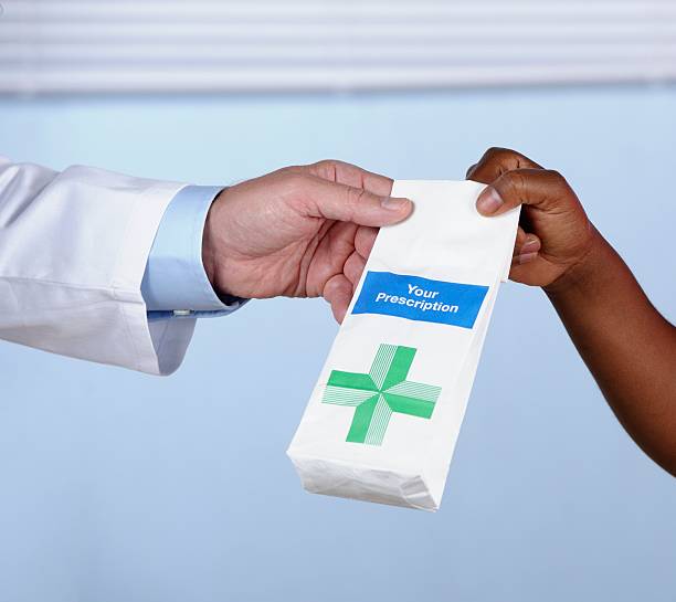istock Pharmacist Handing Over Prescrption Medication 476374403