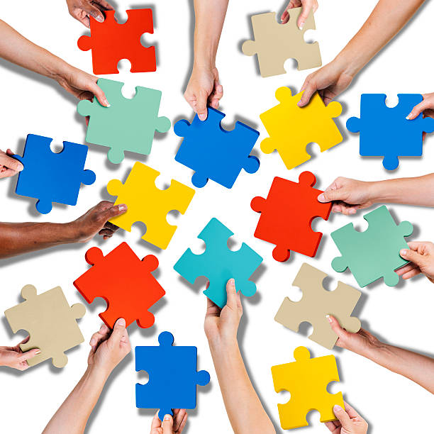 istock Group of Hands Holding Jigsaw Pieces 476374480